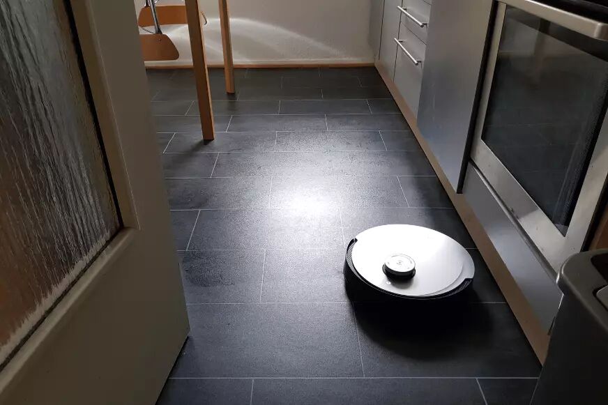 The Ecovacs Deebot X1 OMNI mops the kitchen floor